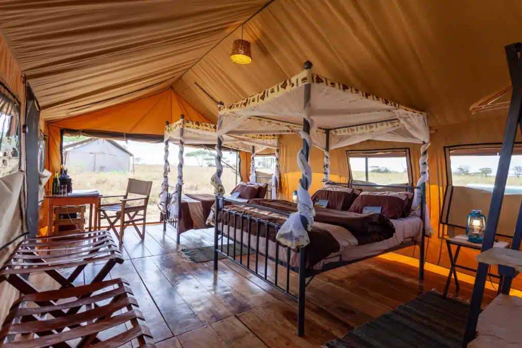 Twin beds inside a guest tent at Mawe Tented Camp