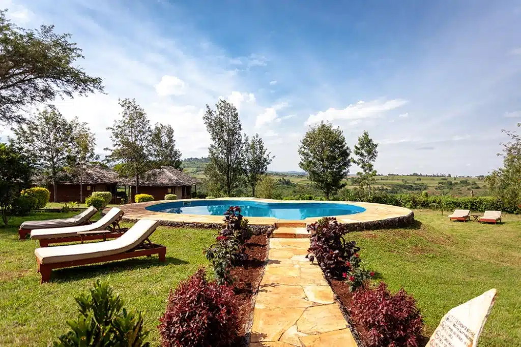 Swimming pool and sun loungers at Karatu Tented Lodge