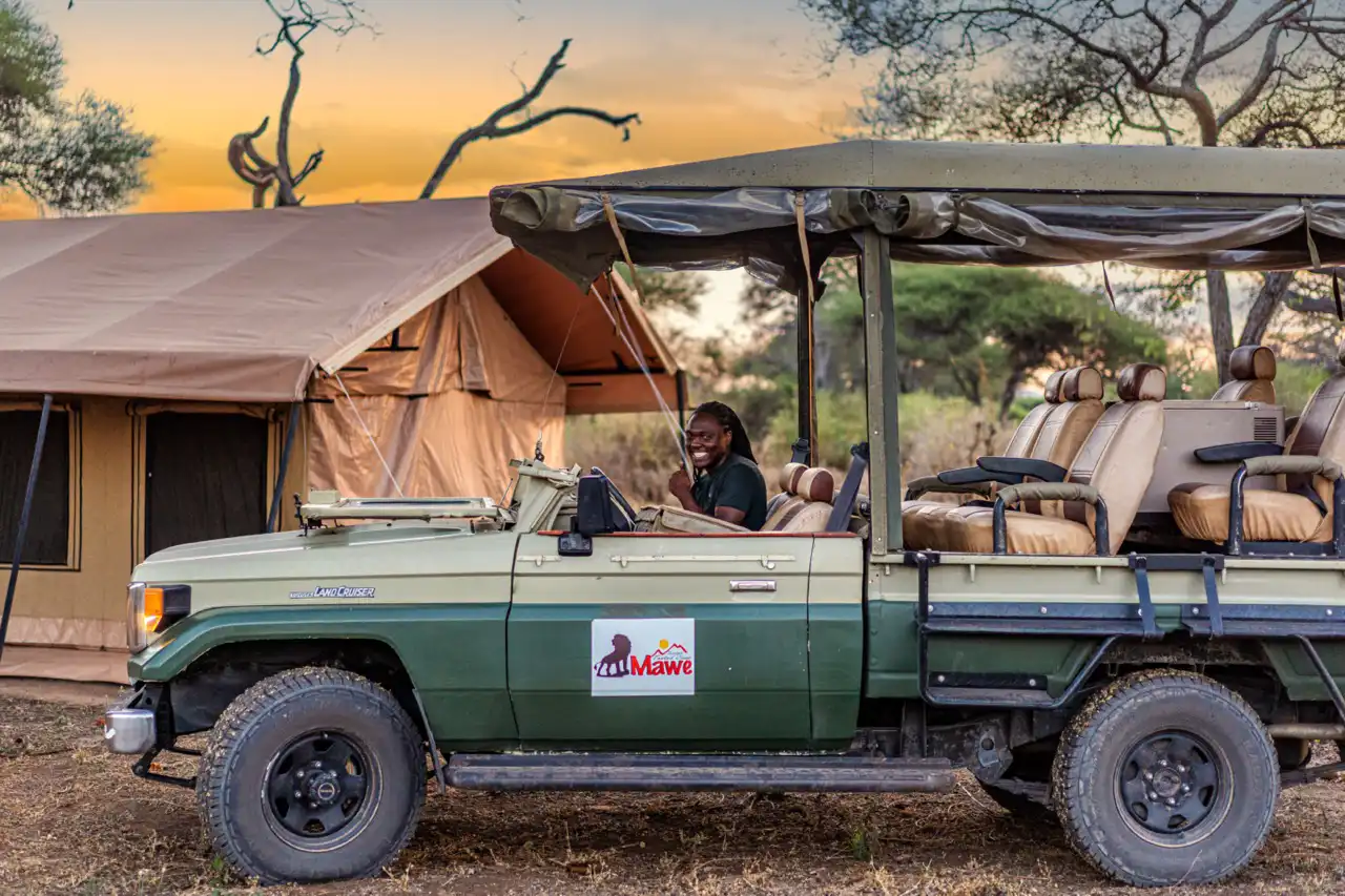 3. A safari vehicle carrying passengers in the back, exploring the diverse wildlife of Tarangire National Park.