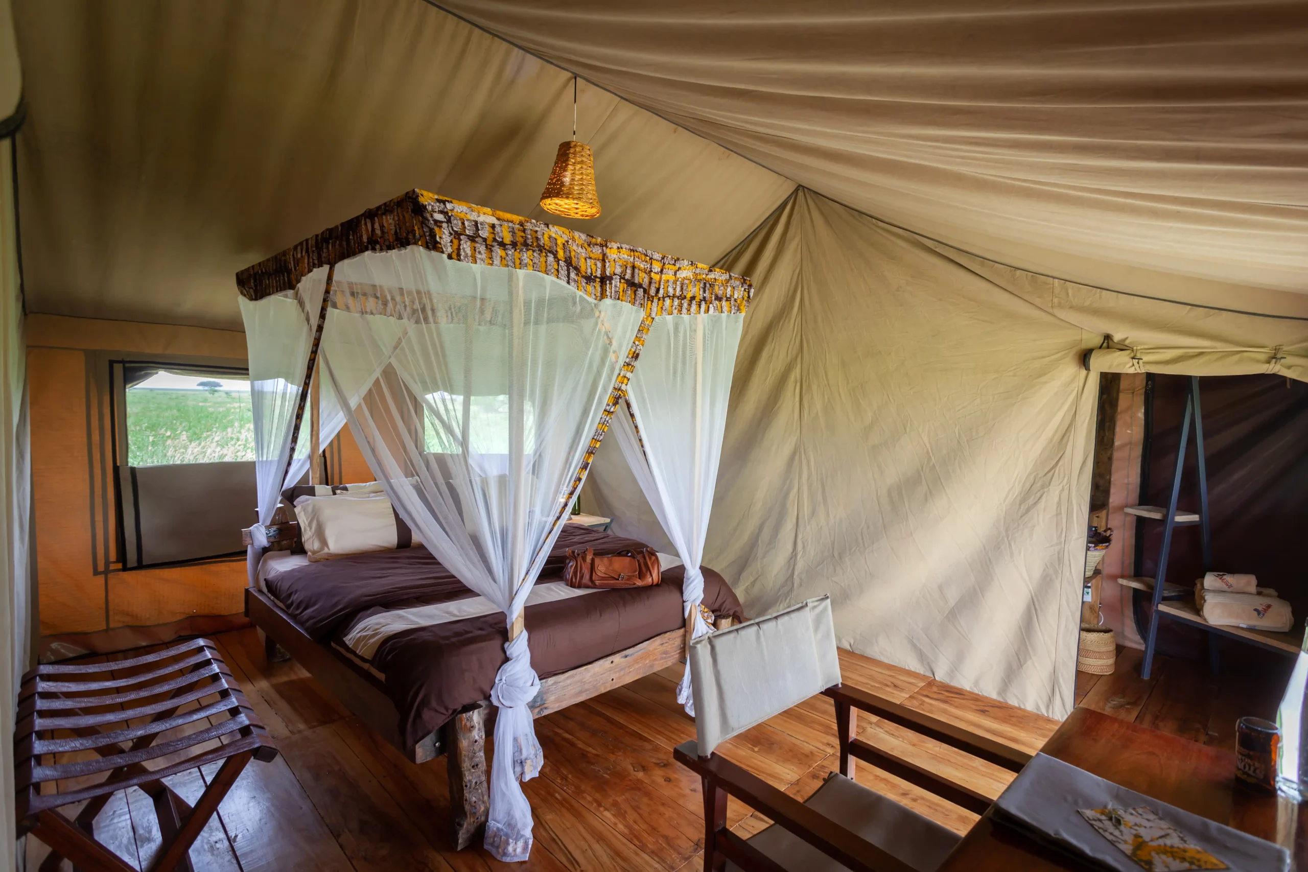 Family tent bedroom with a canopy bed at Mawe Tented Camp