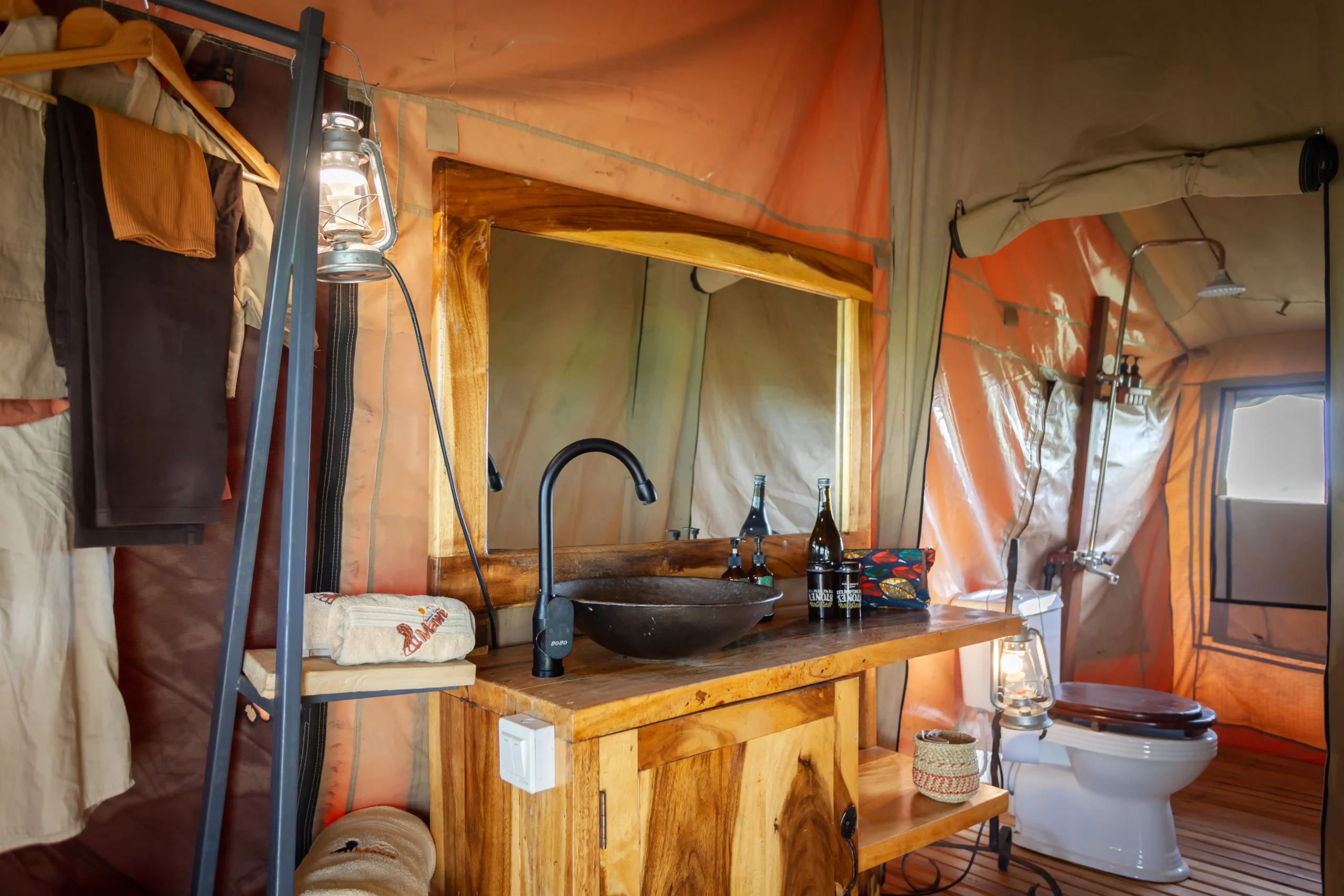 Tent bathroom with stone basin and copper fittings