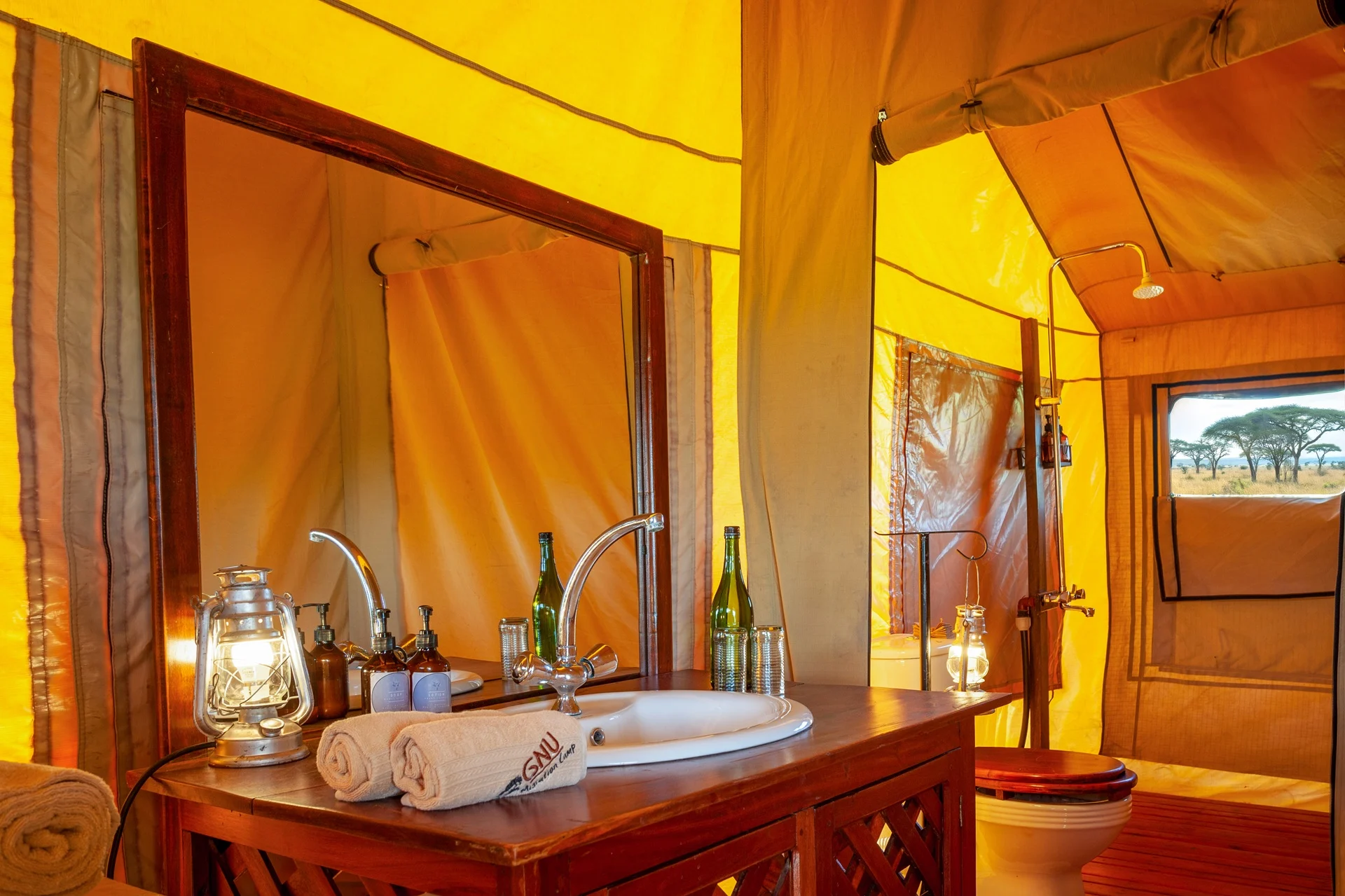 Ensuite bathroom with a hot bucket shower in a tent at Gnu Ndutu Camp