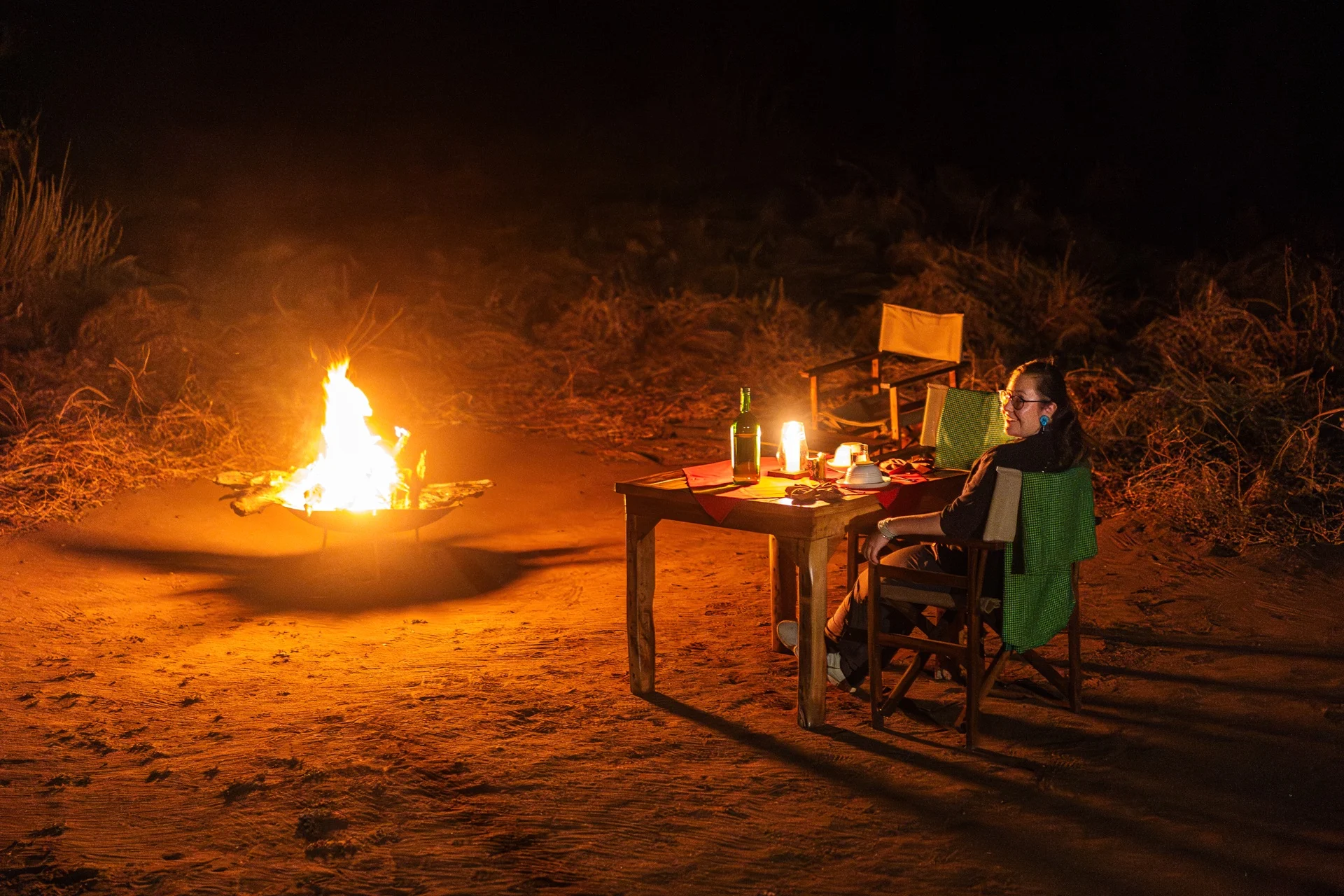 Private bush dinner beside campfire at Baobab Tented Camp