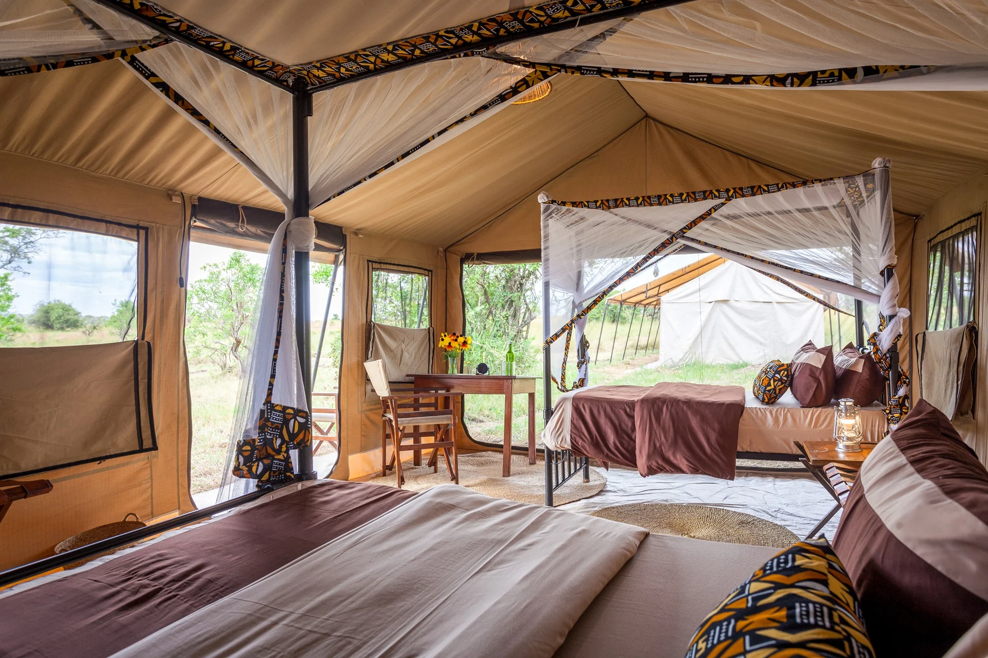 Inside a triple tent with three beds at Gnu Ndutu Camp