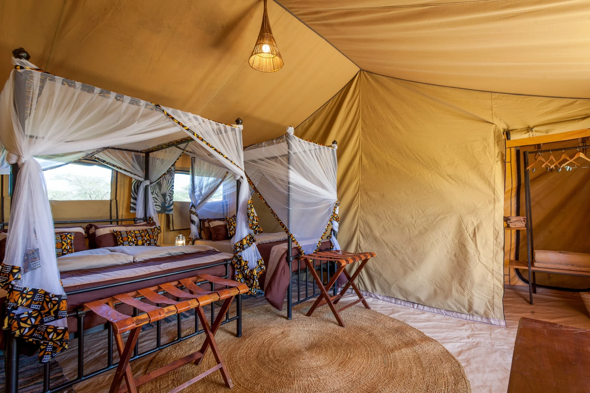 Twin beds under mosquito nets in a tent at Gnu Ndutu Camp